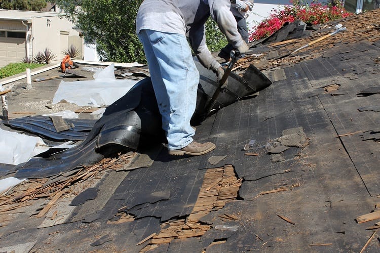 Man Replacing Old Roof