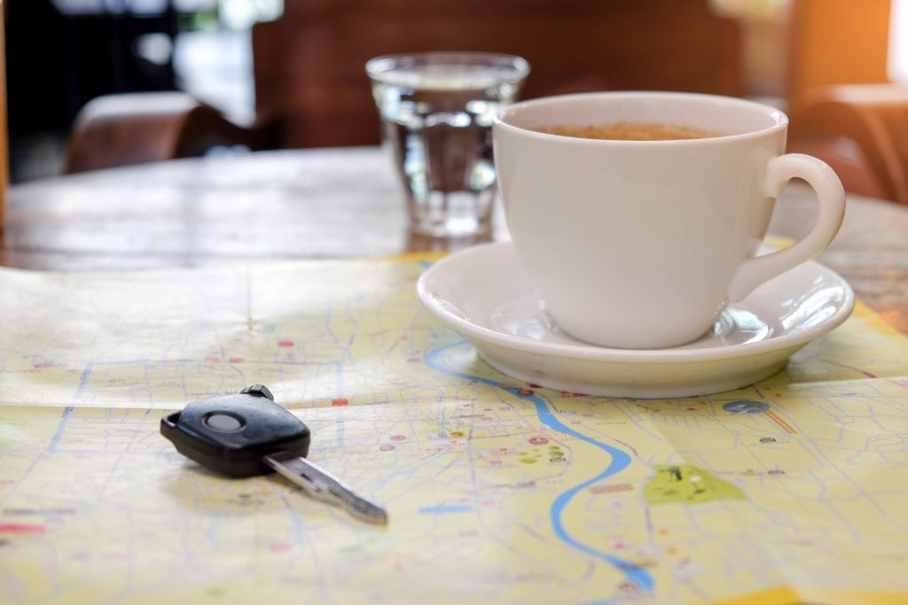 a cup, a map, and a key