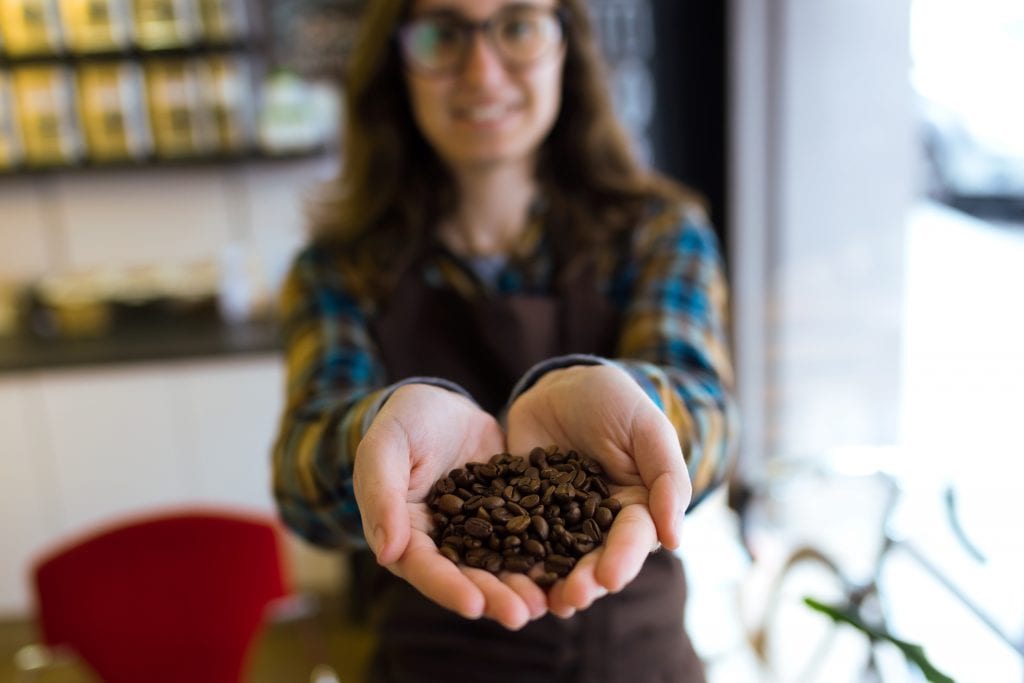 a women holding coffee grounds